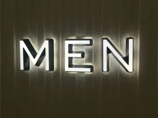 White front lit mini channel letters on textured indoor wall