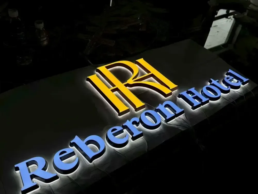Gold logo and blue backlit mini channel letters for hotel