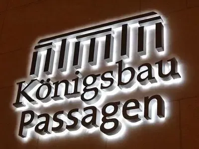 Silver backlit channel letters on dark glass office entrance