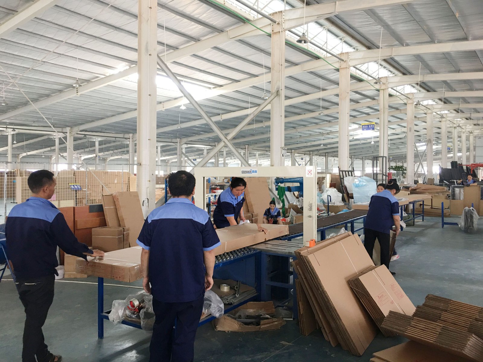 Factory team preparing products for protective export packing