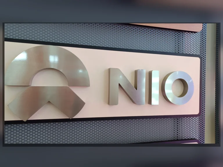 Reflective NIO lettering and a matching logo displayed on a light rectangular panel.