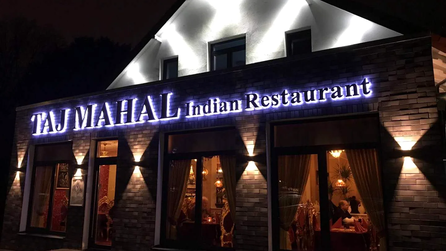 TAJ MAHAL restaurant channel letter sign at night