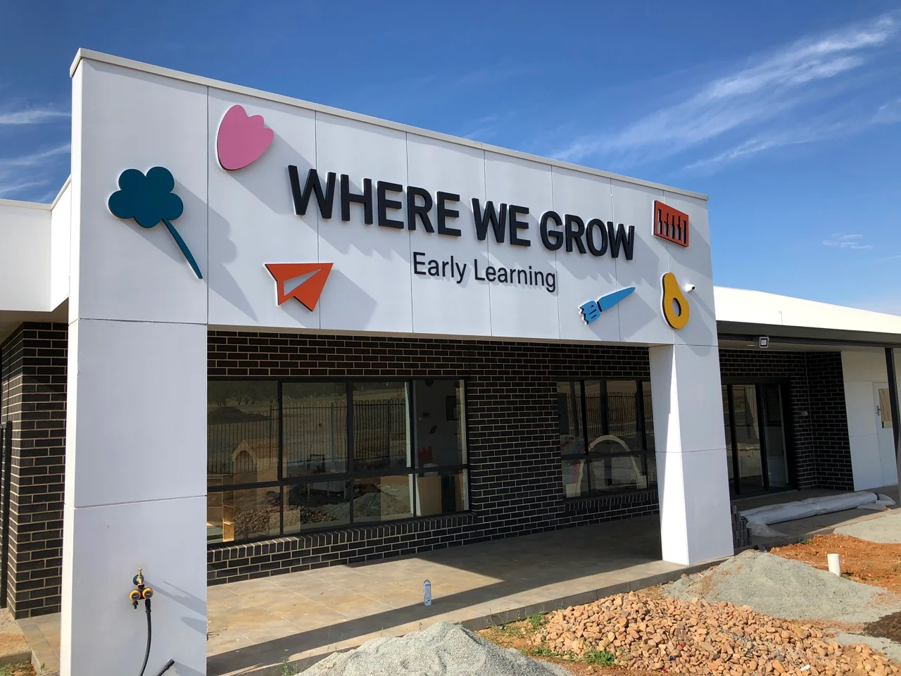 WHERE WE GROW exterior sign in daytime