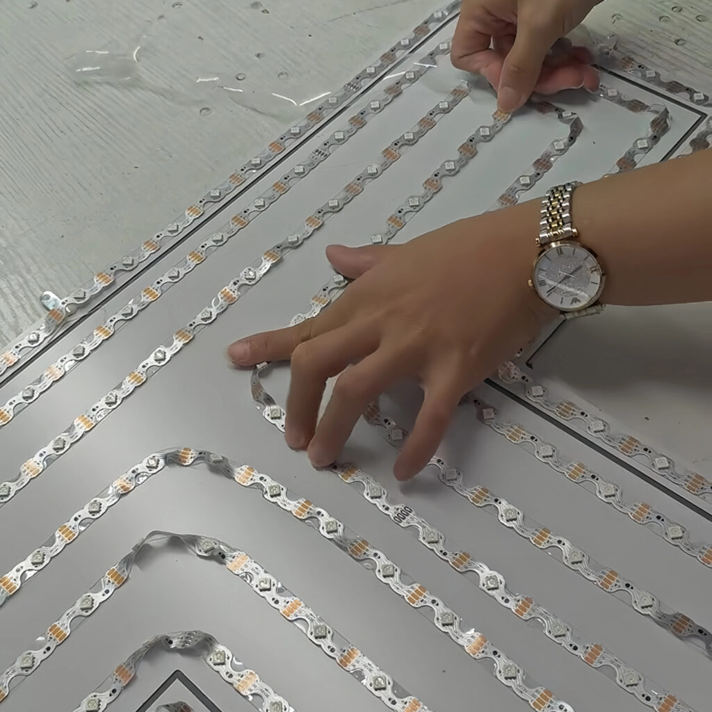 Installing LED modules on a sign base plate according to the lighting layout