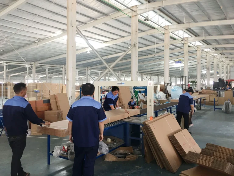 Workers assembling and packing products into cartons