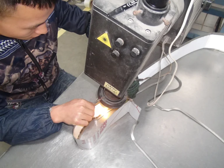 Technician welding a metal channel letter return