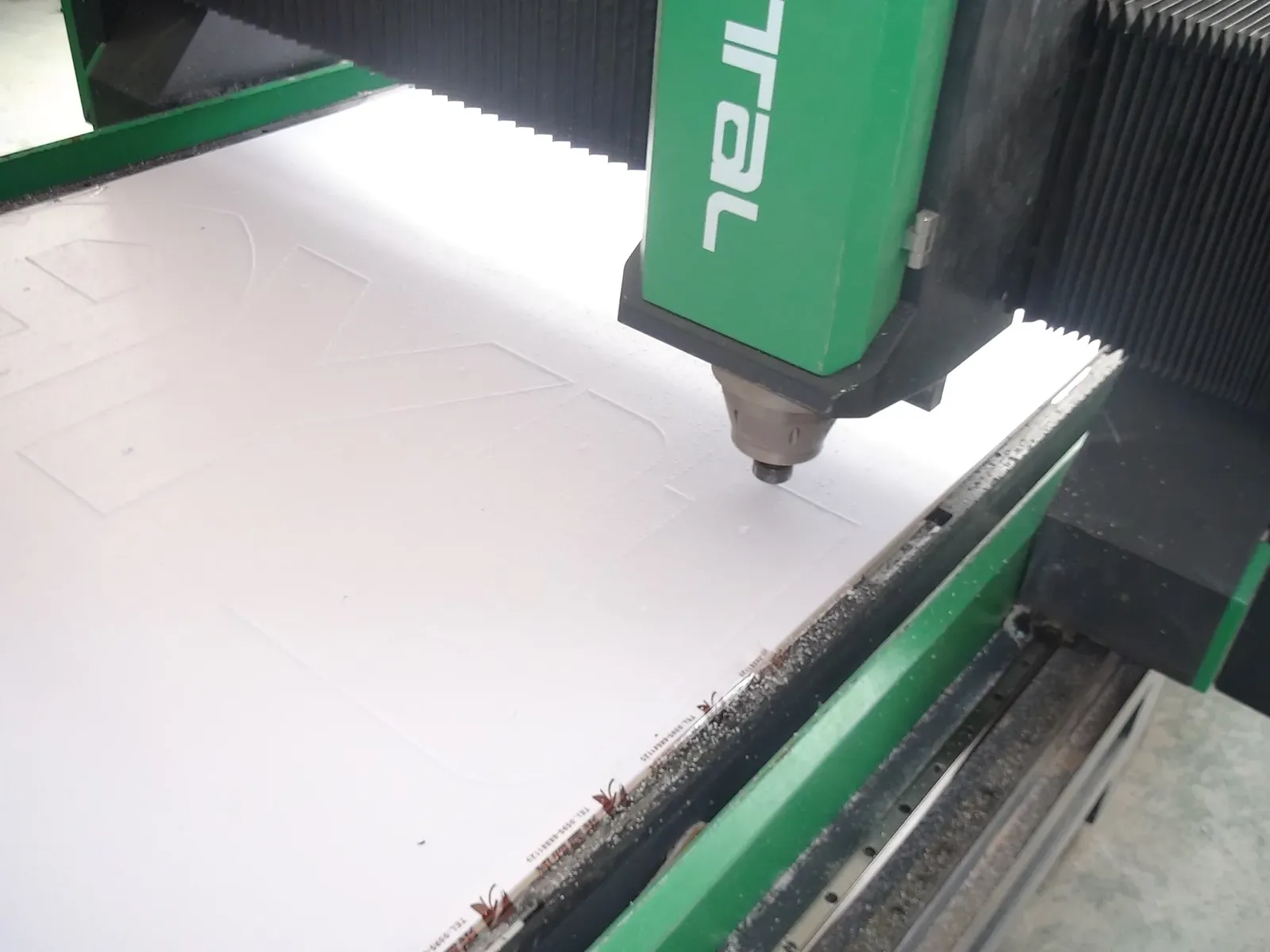 CNC engraving and routing of sheet material for custom sign components