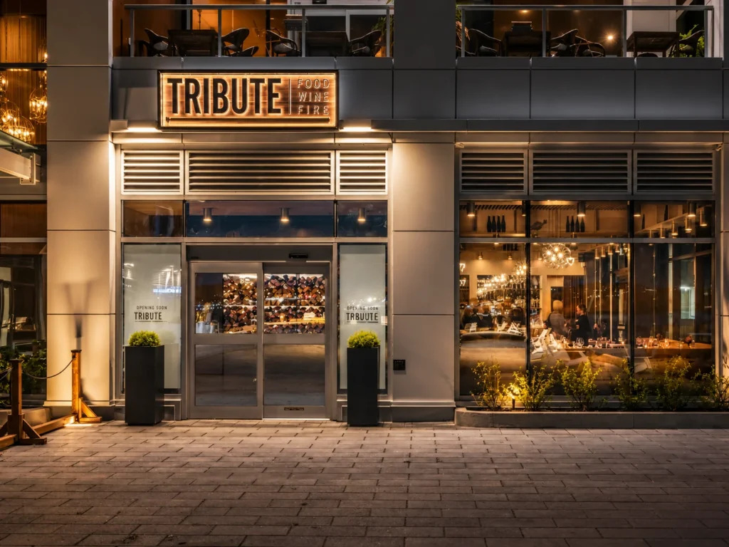 Illuminated restaurant signage installed on a modern hospitality storefront