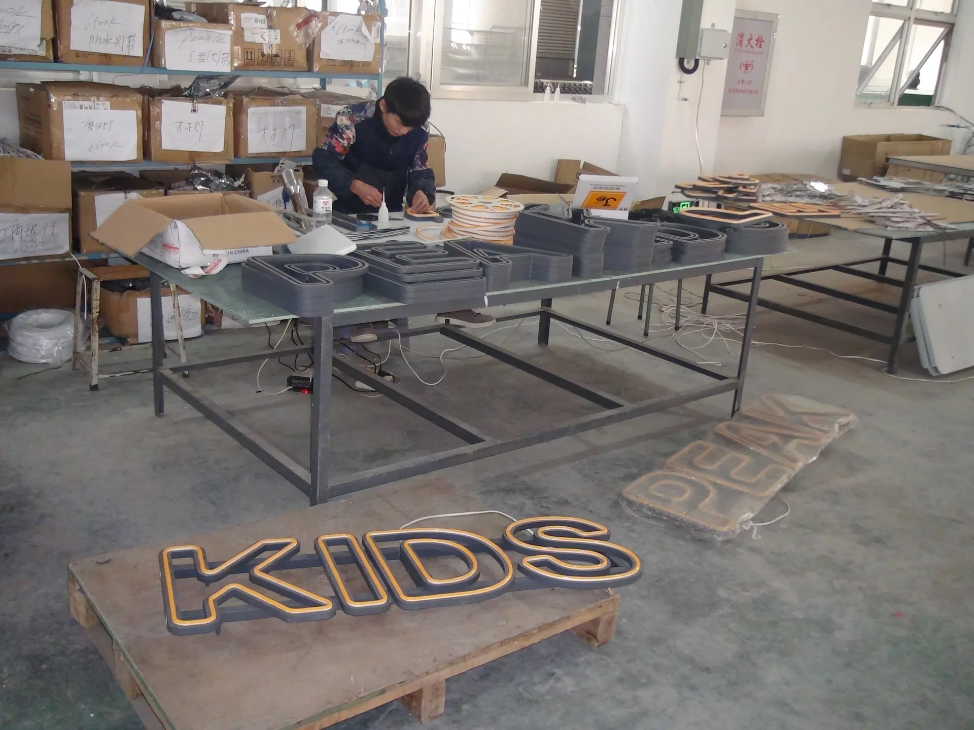 Neon flex letters and tools on an assembly table