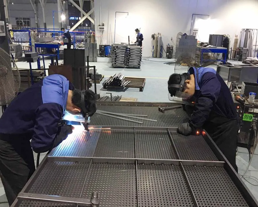 Technicians welding a fabricated metal frame