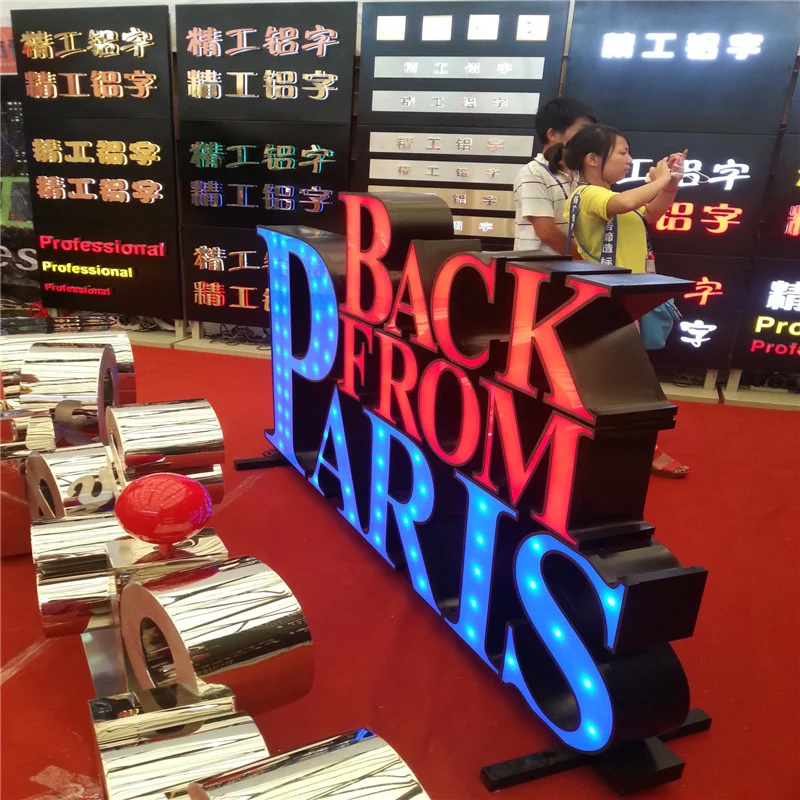 Oversized red, blue and white letters arranged at an exhibition display.