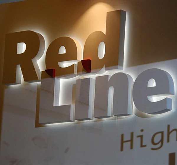 Dimensional Red Line lettering on a display panel with visible layered depth and surrounding light.