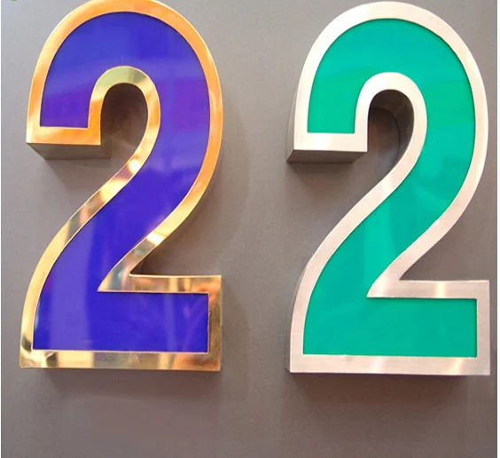 Two dimensional number 2 samples with purple and green faces and contrasting metallic edge finishes.