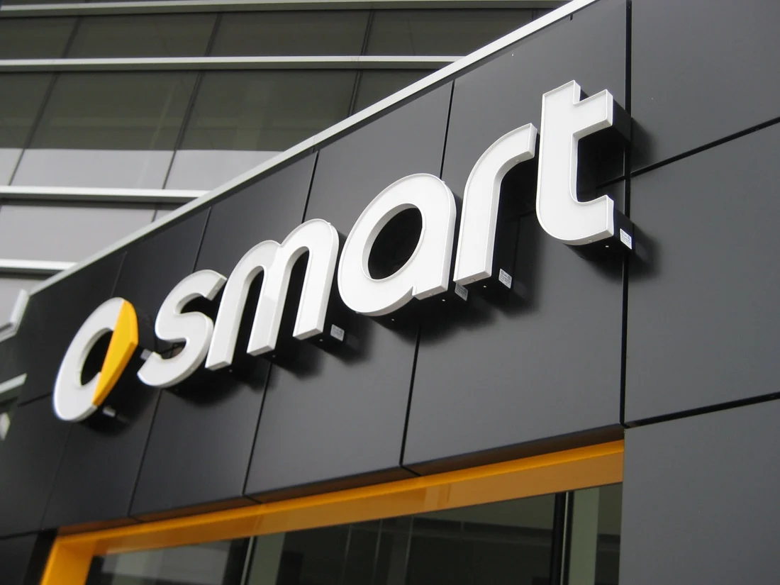 Dimensional storefront letters mounted on a dark commercial facade