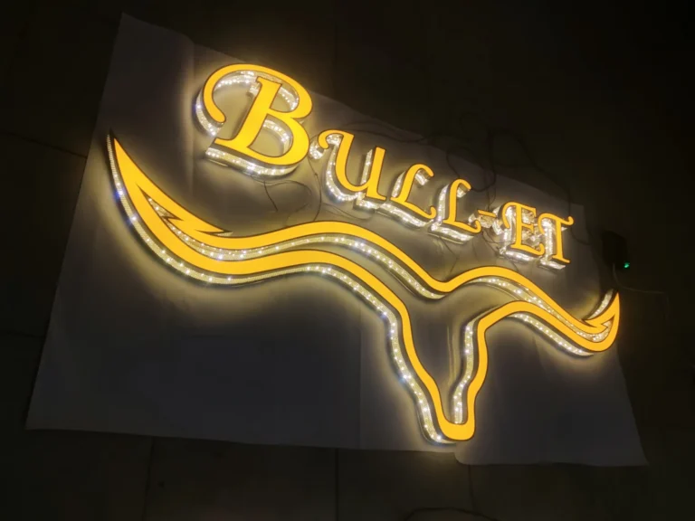 A bull-head outline and dimensional wordmark with visible light points and warm surrounding illumination.