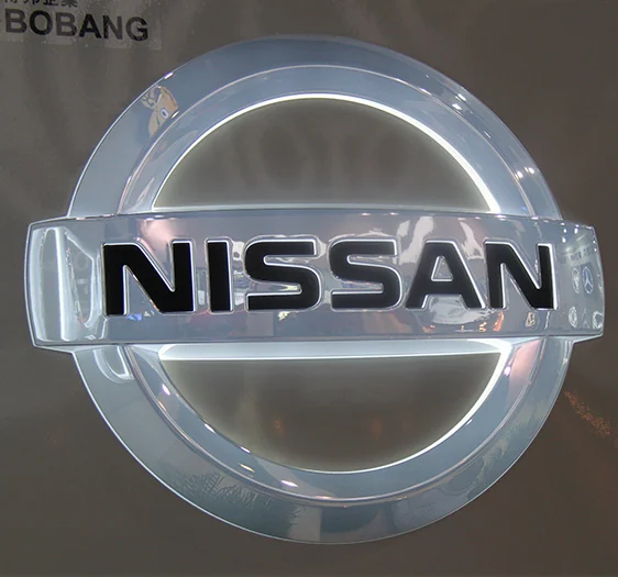 A round dimensional emblem with a raised horizontal wordmark and reflective surfaces.