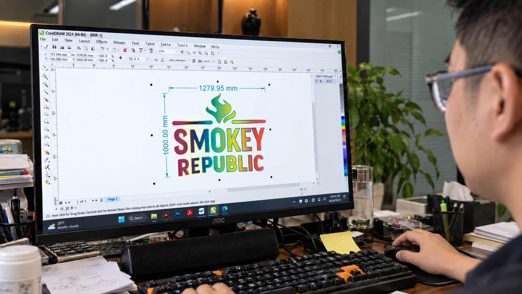 Designer reviewing sign artwork and dimensions on a desktop monitor