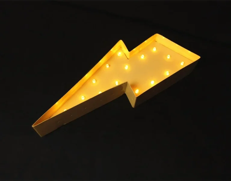 A yellow lightning-shaped sign with illuminated bulbs and raised side edges.