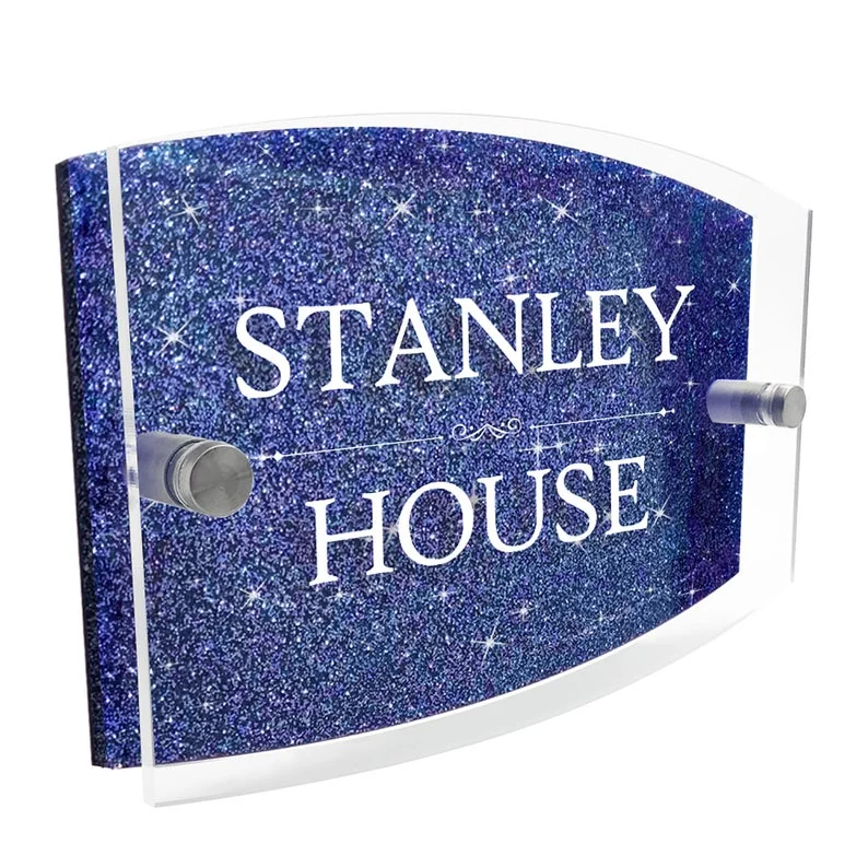 A curved blue plaque reading STANLEY HOUSE, fixed with visible stand-off fasteners.