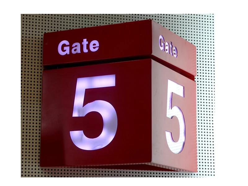 A red multi-face identification sign with illuminated Gate lettering and the number 5.