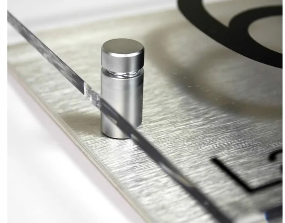 Close-up of a cylindrical stand-off fastener holding a metal sign panel.