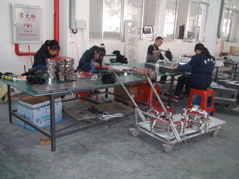 Technicians assembling sign letters at workshop tables