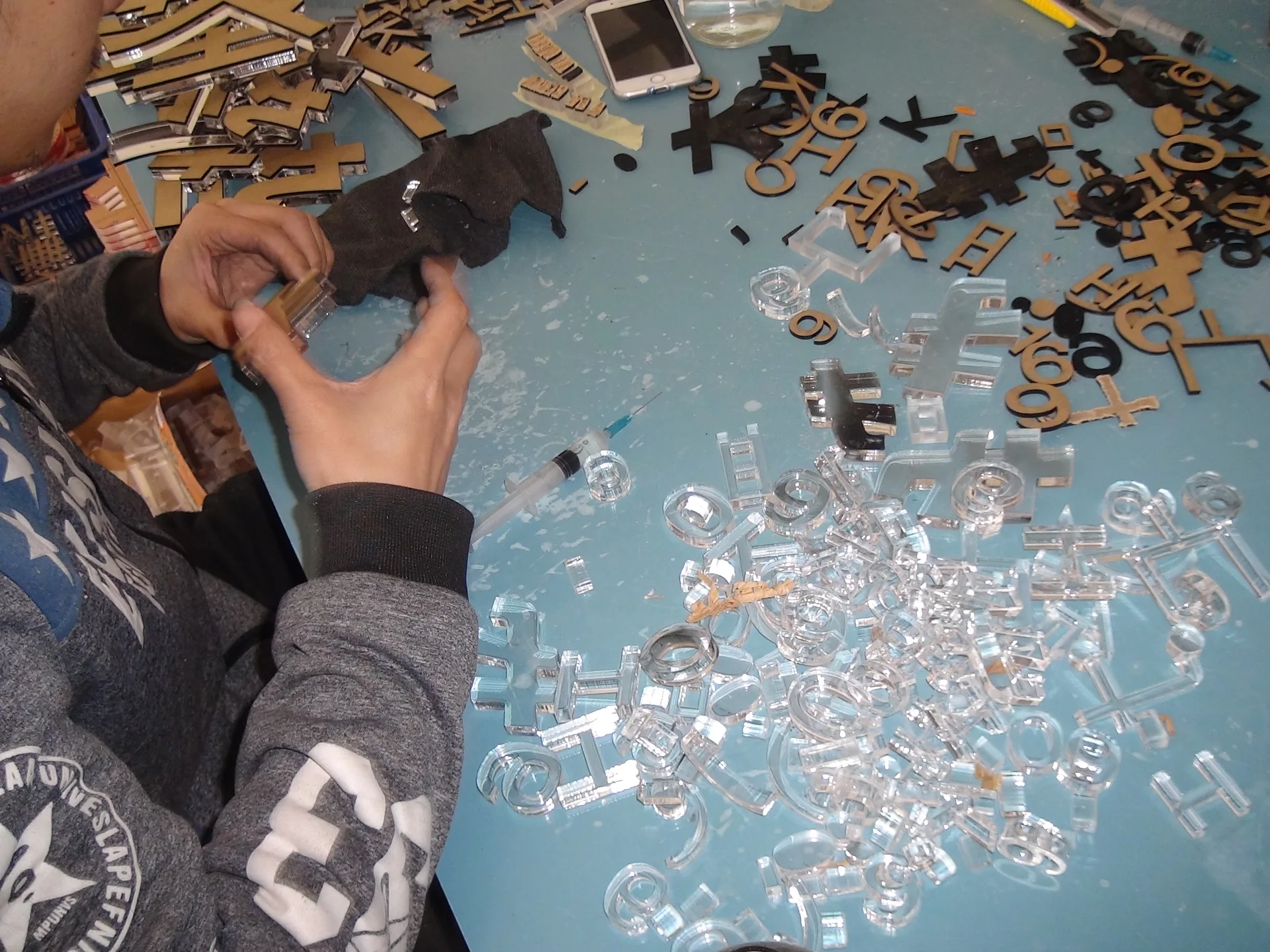 Technician assembling small dimensional metal letters
