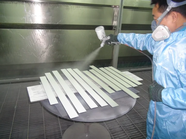 Technician spray finishing metal components